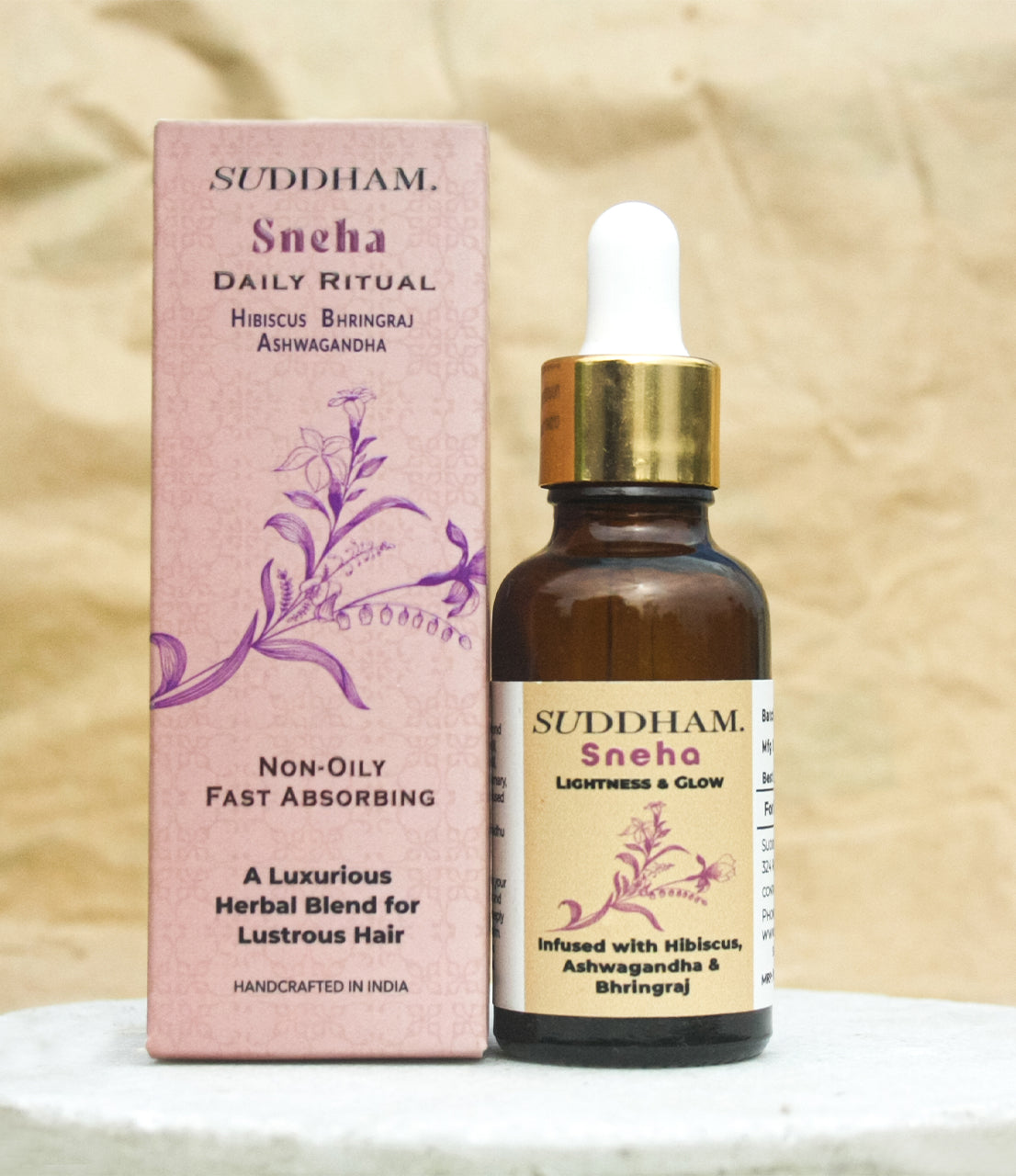 Suddham Sneha Hair Oil bottle with luxury box featuring floral Ayurvedic motif.